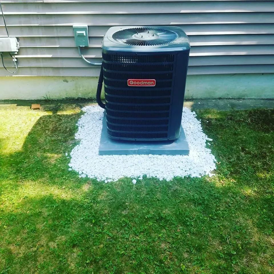 New outdoor AC condenser installed on a stone pad by RPM